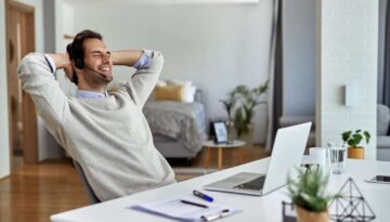 young-happy-entrepreneur-relaxing-with-hands-head-after-working-computer-home_637285-6065